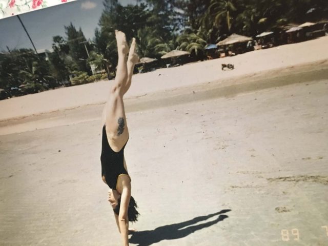 Tiger doing a handstand on the shores of Thailand.