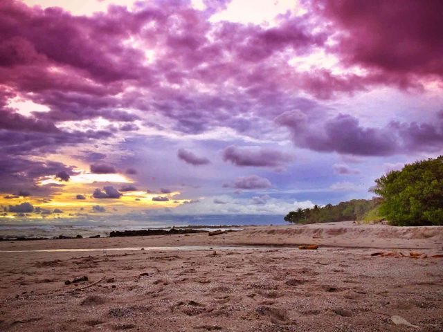 sunset on the beach in santa teresa, costa rica